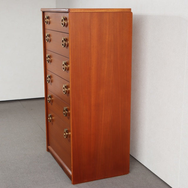 Mid-century British vintage teak chest with rich wood grain, brass ring handles, and tapered legs.