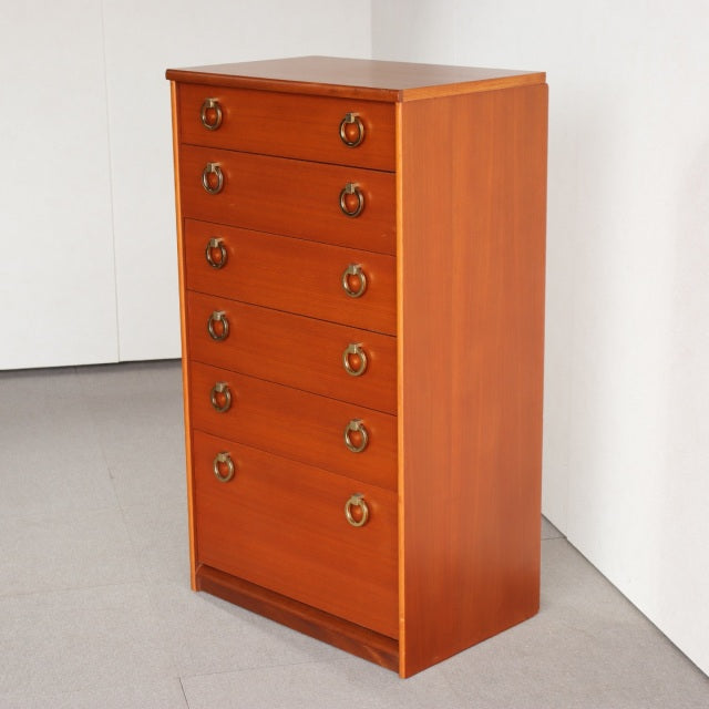 Mid-century British vintage teak chest with six drawers, brass ring handles, and smooth wood grain finish.