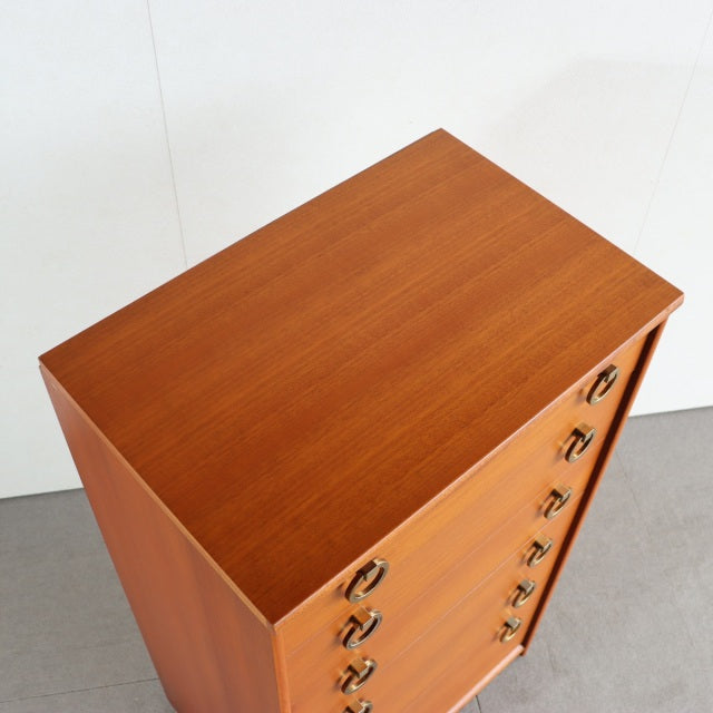 Vintage teak chest with smooth wood grain, British mid-century design, Danish-style brass ring drawer pulls, slender tapered .