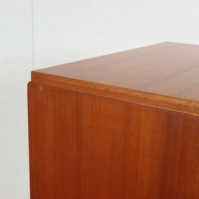 Vintage British mid-century teak chest corner showing smooth wood grain and clean Danish-inspired lines.