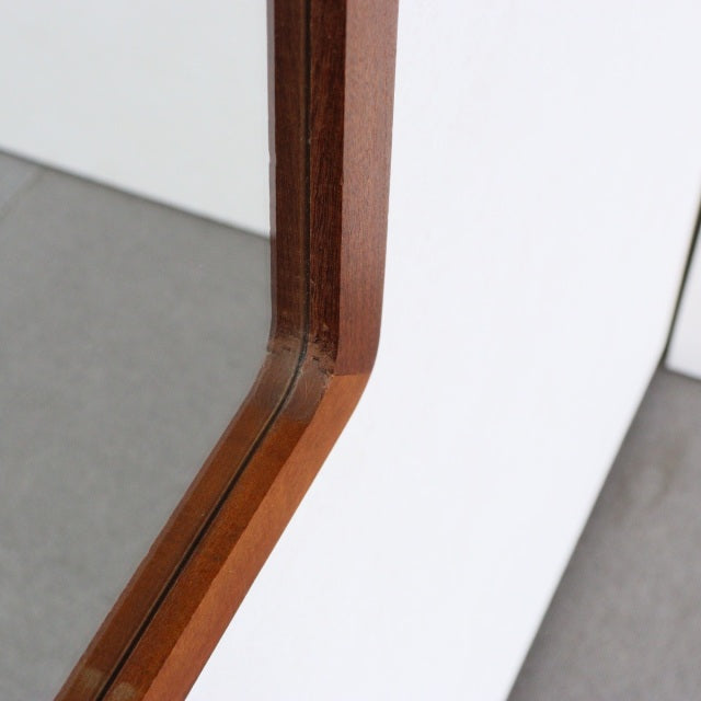 Mid-century British vintage teak trapezoid wall mirror with rich wood grain and sleek angled frame.