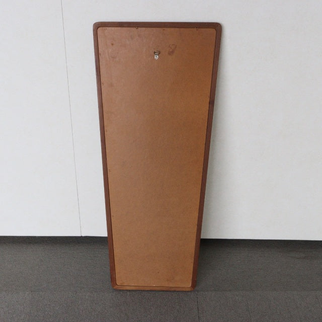 Vintage British mid-century trapezoid teak wall mirror back with visible wood grain and hanging hardware.