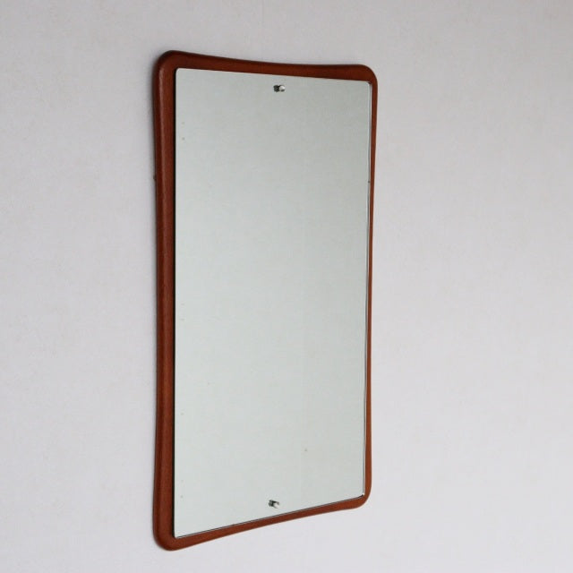 Mid-century British vintage wall mirror with gently curved teak frame and smooth wood grain.