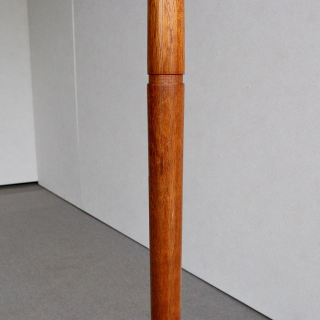 Mid-century teak floor lamp leg with warm wood grain and smooth finish, British vintage style.