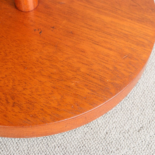 Circular teak wood surface with rich grain patterns and smooth mid-century finish, British vintage style.