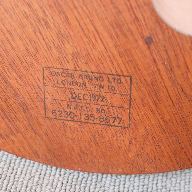 Close-up of teak wood showing vintage mid-century British floor lamp base with visible wood grain and original maker's mark.