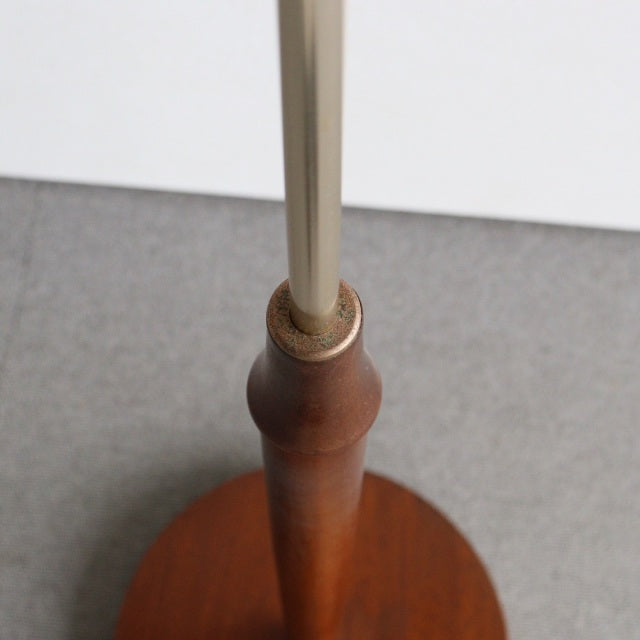 Mid-century British vintage teak floor lamp base with smooth wood grain and brass fittings.