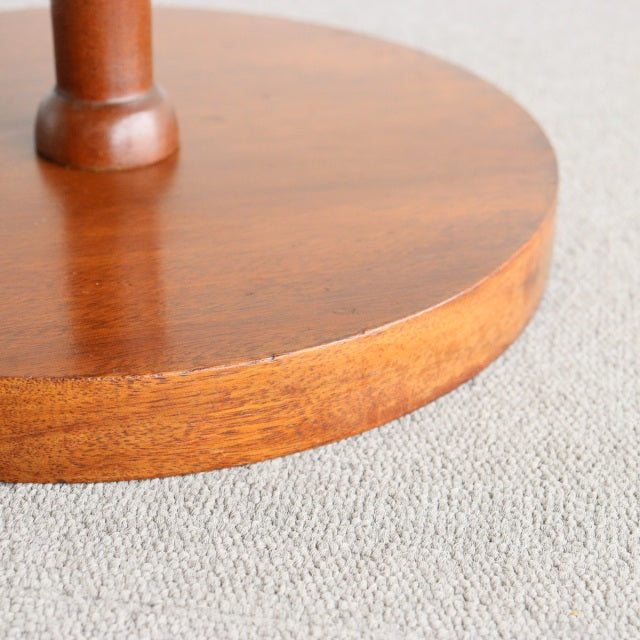 Round teak base with rich wood grain and smooth finish on vintage mid-century floor lamp.