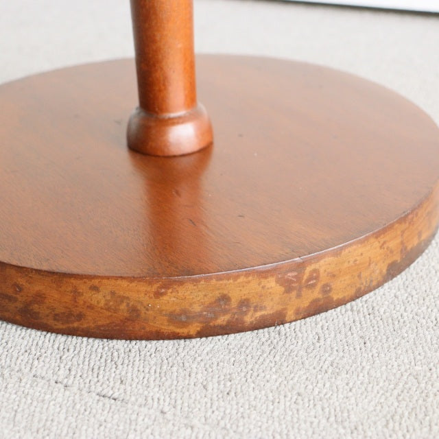 Round teak floor lamp base with visible wood grain and warm mid-century vintage finish.