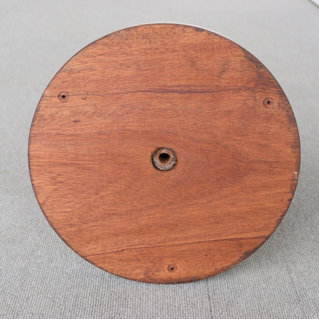 Round vintage teak wood base with visible grain and central metal fitting, mid-century British design.
