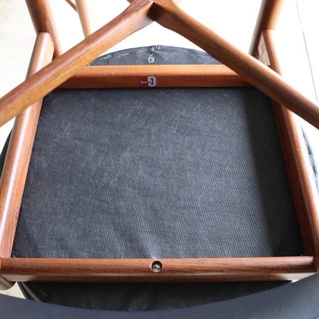 Vintage British G-Plan mid-century teak dining chair bottom view showing wood grain and frame craftsmanship.