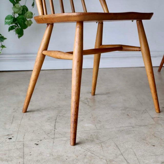 Vintage Ercol Goldsmith mid-century teak dining chair with natural wood grain and tapered legs.