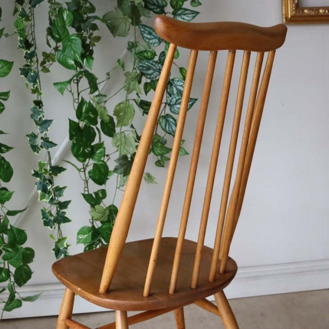 Vintage British mid-century Arcol Goldsmith high-back chair in natural teak with slender vertical spindles and smooth curved .