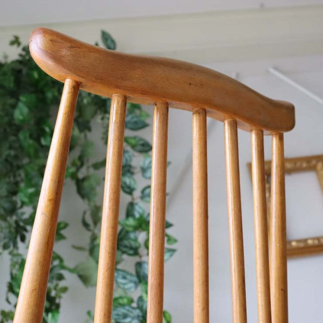 Vintage mid-century Ercol Goldsmith high-back dining chair in natural teak with slender spindled backrest and smooth curved.