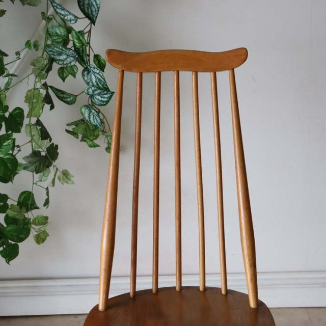 Vintage British Ercol Goldsmith dining chair in teak with a high spindle back and curved top rail, mid-century design with.