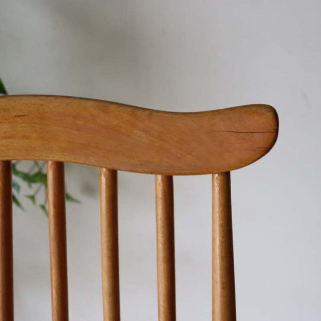 Vintage British Ercol Goldsmith dining chair in teak with curved top rail and slender spindle back, mid-century design.