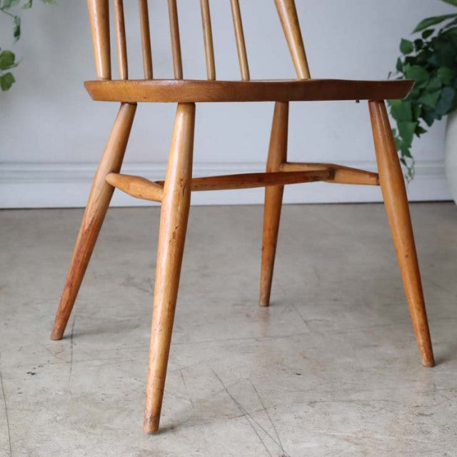 Mid-century British vintage Ercol Goldsmith dining chair in warm teak with spindle back and tapered legs showing natural.