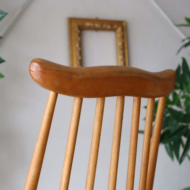 British mid-century vintage Ercol Goldsmith dining chair in warm teak with smooth curved backrest and slender spindle legs.