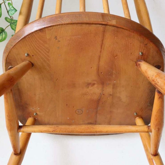 Vintage British mid-century Ercol Goldsmith dining chair in teak, curved spindled back, smooth wood grain on seat and.