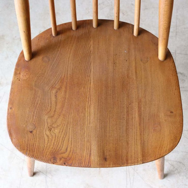 Vintage British Ercol Goldsmith mid-century chair seat in warm teak wood with visible grain and rounded edges.
