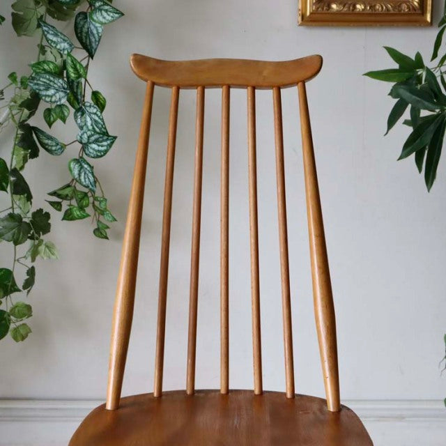 Vintage British Ercol Goldsmith dining chair in teak with tall spindle back and tapered legs, mid-century Denmark style.