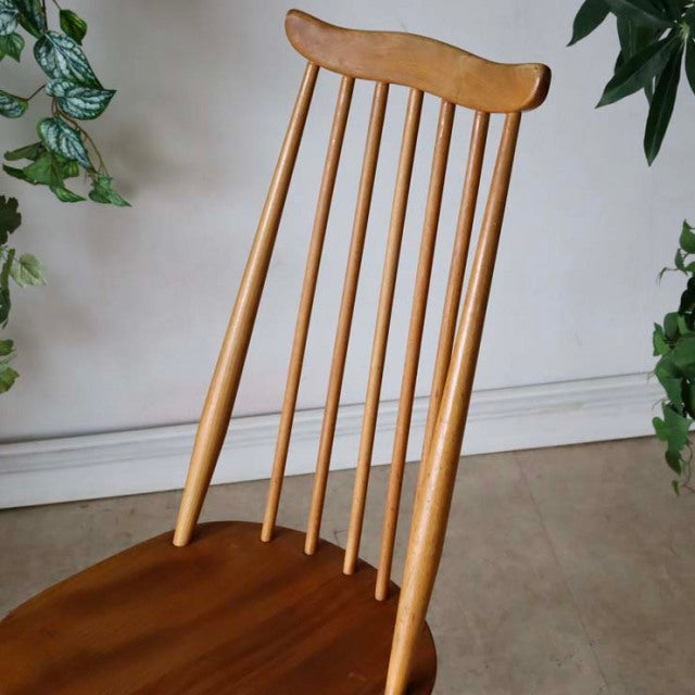 Vintage British mid-century Ercol Goldsmith dining chair in warm teak with a tall spindle back and gently curved top rail.