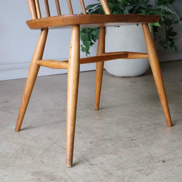 Vintage teak mid-century British dining chair by Ercol with tapered legs and visible wood grain.
