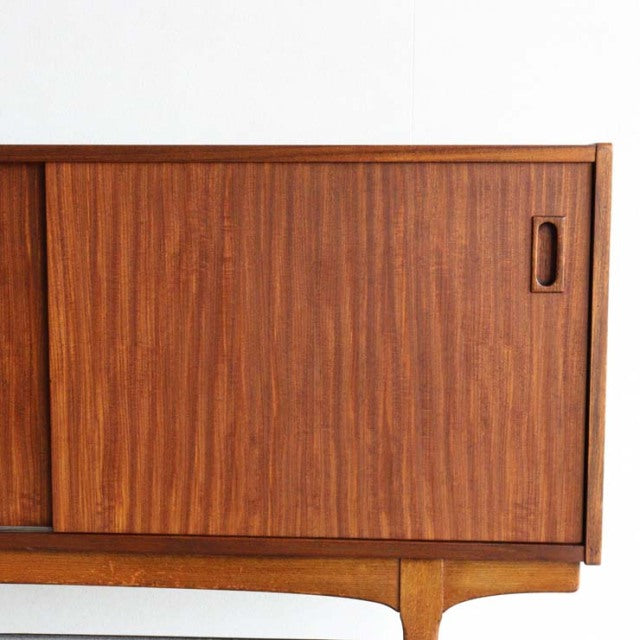 Mid-century British vintage teak sideboard by Nathan with sliding doors and visible wood grain.
