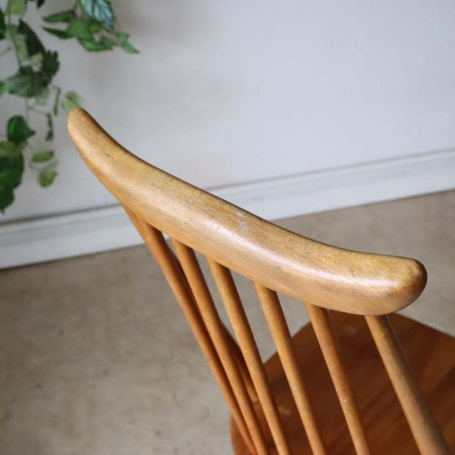Vintage British mid-century Ercol dining chair in teak with curved top rail and slender spindle backrest.