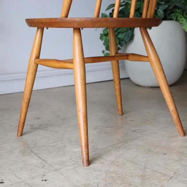 Mid-century British vintage Ercol Goldsmith dining chair in teak with tapered legs and visible wood grain.