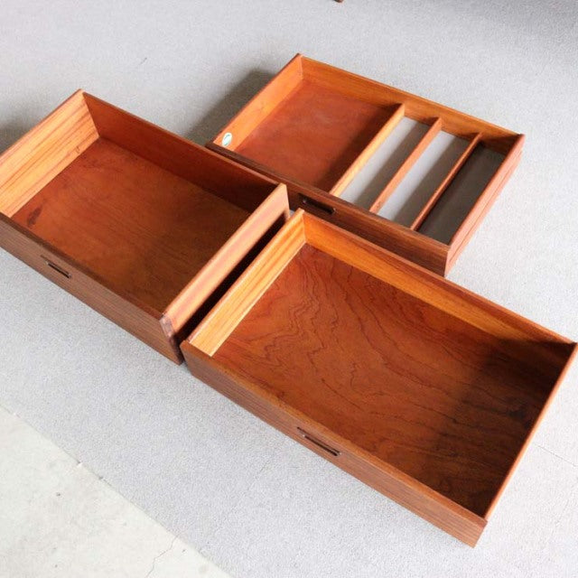 Open teak drawers showing rich wood grain and mid-century British Nathan sideboard craftsmanship with clean lines and smooth .