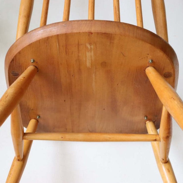 Underside view of vintage teak Ercol Goldsmith dining chair showing smooth wood grain and sturdy mid-century British.