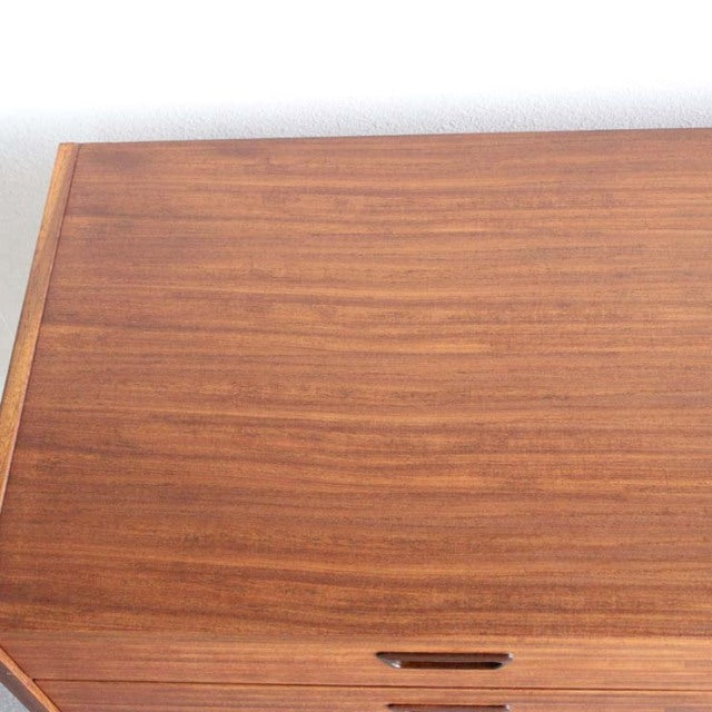 Mid-century British vintage NATHAN sideboard in warm teak with smooth wood grain and sleek rectangular top.