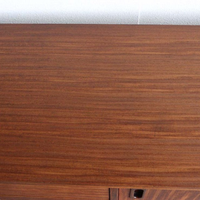 Close-up of vintage teak mid-century British sideboard top showing rich wood grain and smooth finish.