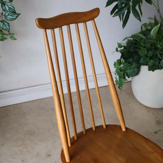 Vintage British Ercol Goldsmith high-back dining chair in natural teak with slender vertical spindles and sculpted top rail, .