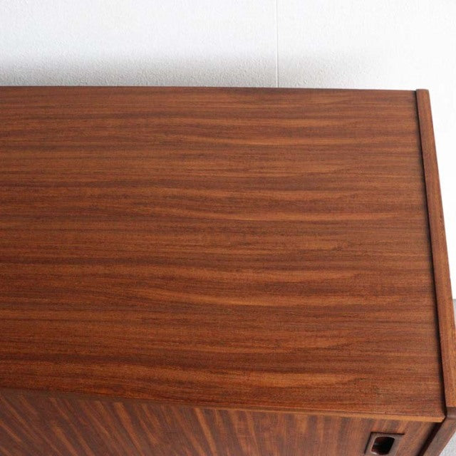 Vintage teak sideboard top surface showcasing rich wood grain and clean mid-century British design lines.