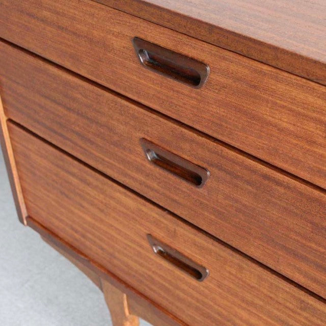 Mid-century British vintage teak sideboard drawers with smooth wood grain and integrated handles.