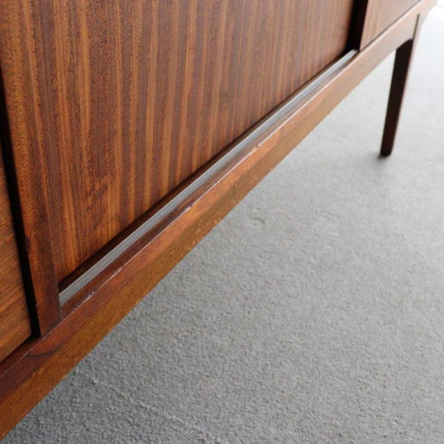 Close-up of vintage teak sideboard leg and wood grain, showcasing mid-century British design from Nathan, Denmark.