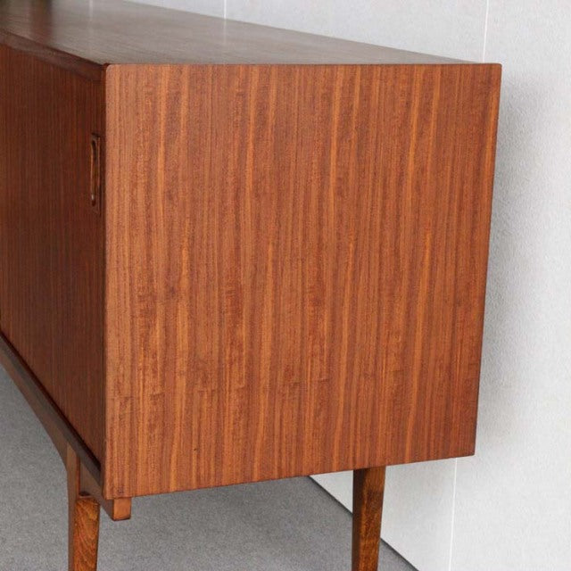 Mid-century British vintage teak sideboard by Nathan with rich wood grain and slender tapered legs.