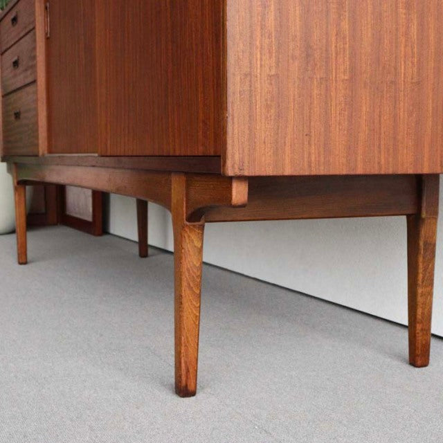 Mid-century British vintage teak sideboard by NATHAN with tapered legs and warm wood grain texture.