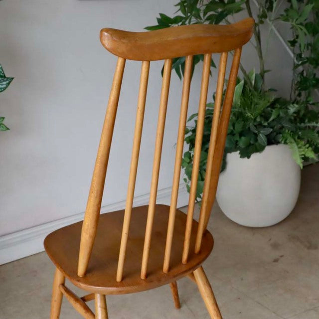 Vintage British Ercol Goldsmith mid-century teak high-back chair with slender spindles and rounded top rail.