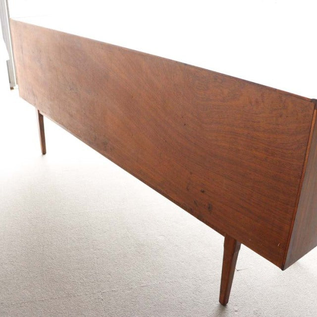 Mid-century British vintage teak sideboard by Nathan with sleek wood grain and tapered legs from Denmark style.