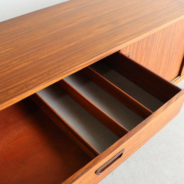 Vintage teak mid-century sideboard drawer open showing wood grain and divided compartments, British design.