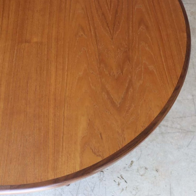 Oval vintage teak dining table top with fine wood grain and smooth rounded edges, mid-century British design.