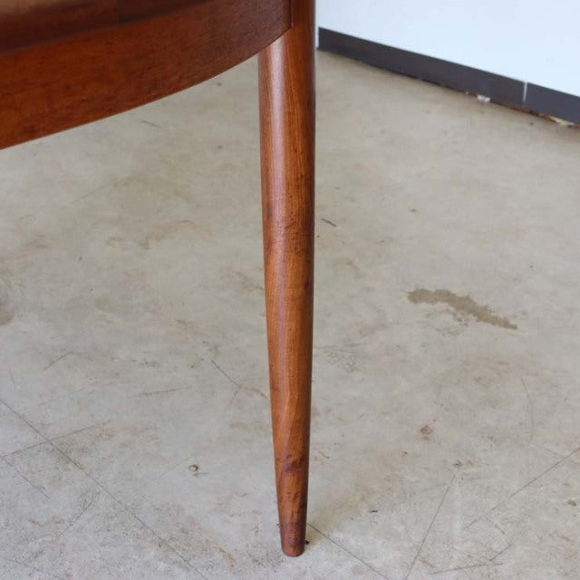 Mid-century British vintage teak dining table leg with tapered cylindrical shape and smooth wood grain.