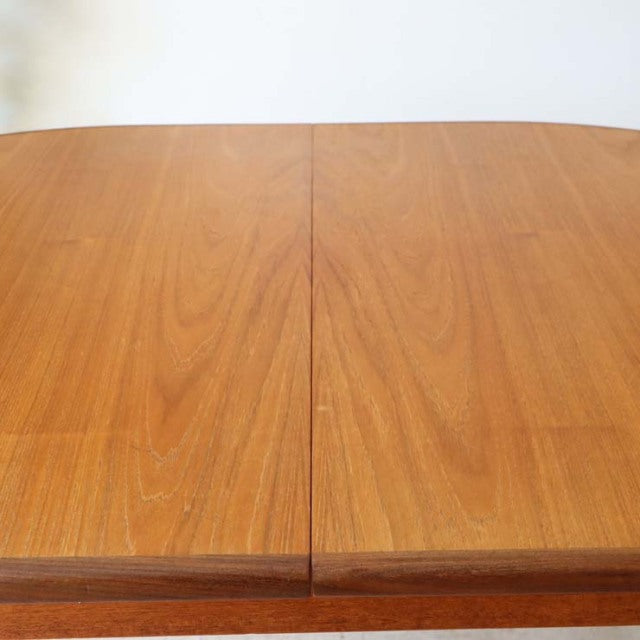 Oval vintage teak dining table by G-Plan with smooth wood grain and clean mid-century British design.