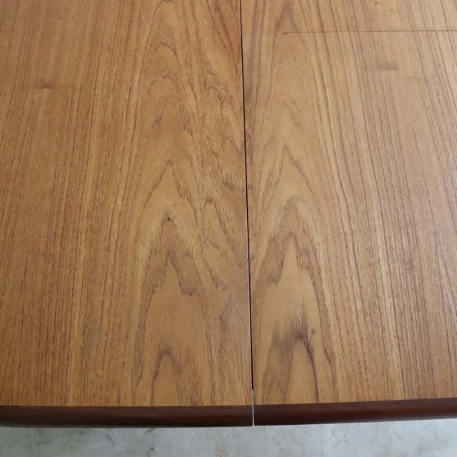 Mid-century British vintage G-PLAN teak dining table with oval top and visible wood grain.