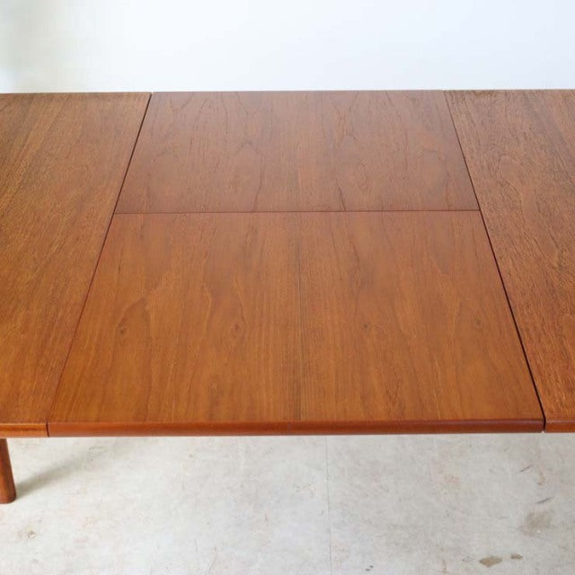 Vintage mid-century British McIntosh dining table in rich teak with distinctive wood grain and clean rectangular form.
