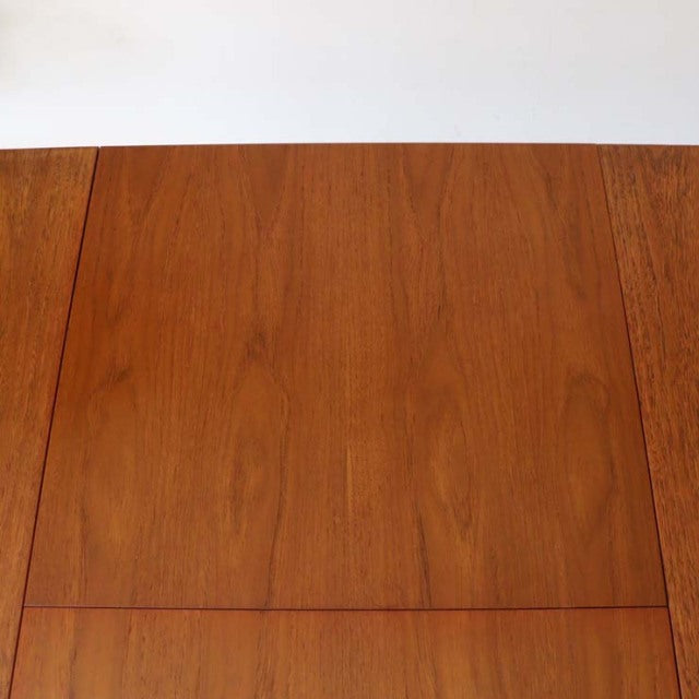 Vintage British mid-century teak dining table with rich wood grain and clean rectangular edges.