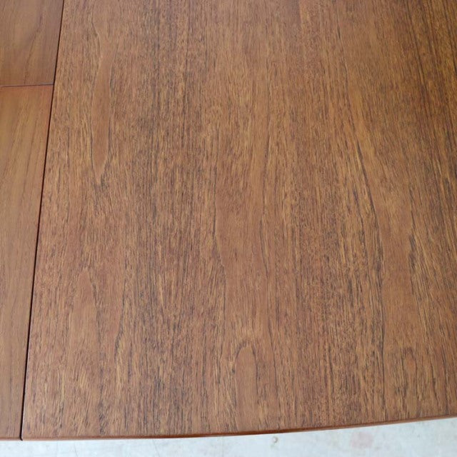 Vintage British McIntosh mid-century teak dining table top with rich wood grain and smooth finish.